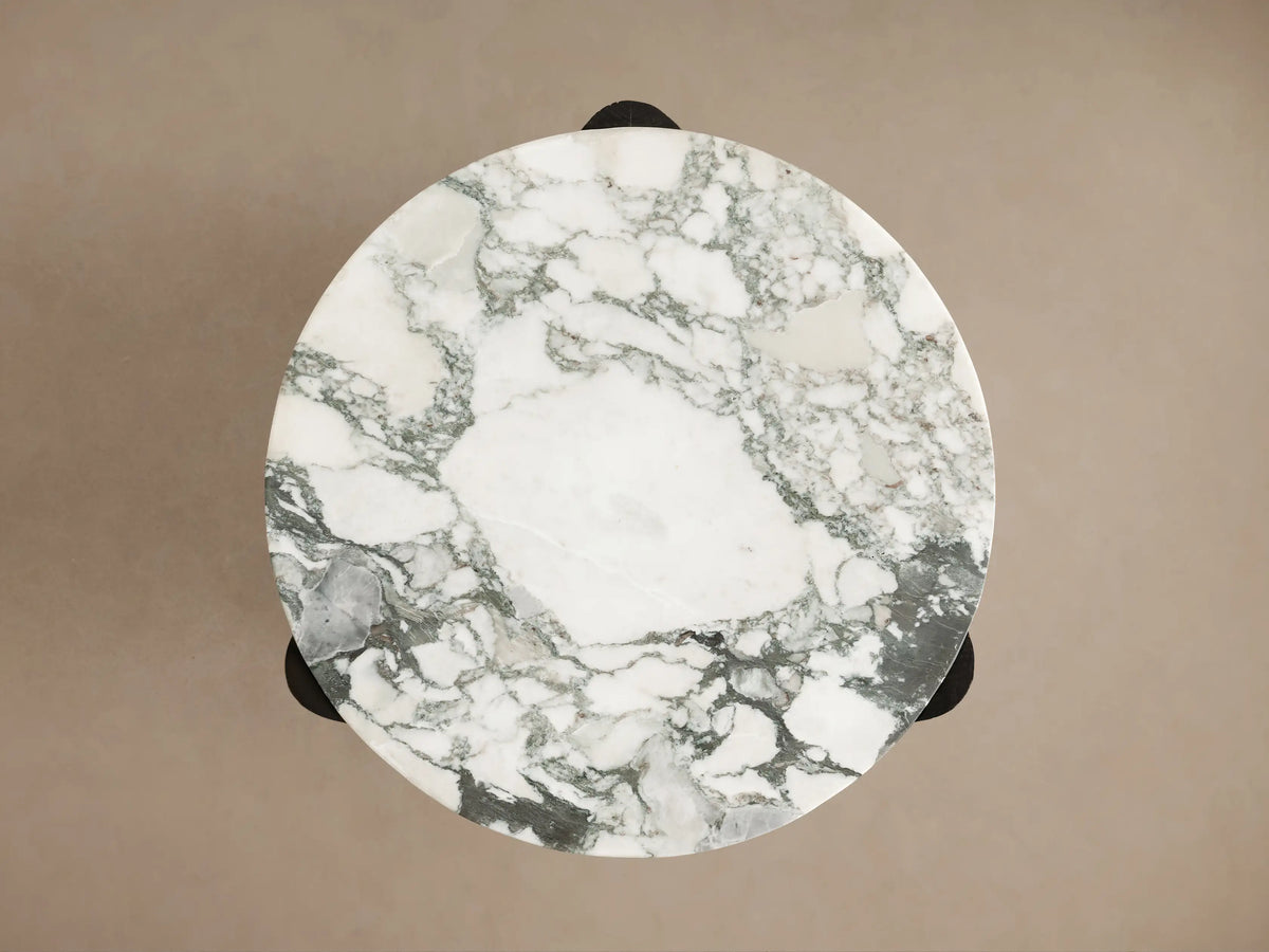 Close-up of the Bellino Martini Table's white marble top with green veining, nesting securely into its dark, wire-brushed oak base.