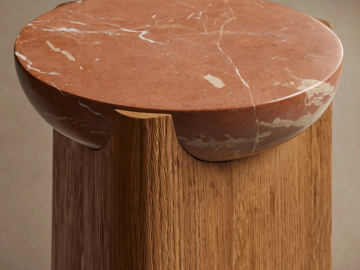 Bellino Martini Table; round pink marble top with white veins, nested on a curved, warm brown oak wood base.