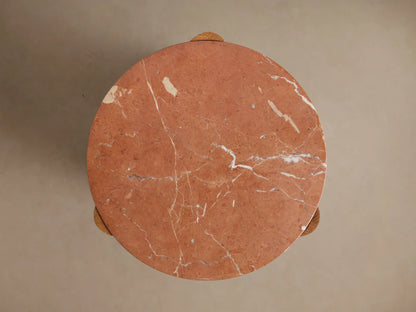 Bellino Martini Table close-up. Round red marble top with white veins nesting in a textured, wire-brushed light brown oak base.