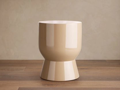 Beige Bridgers Lacquer Stool with a shiny, high-gloss finish. Features a cylindrical top and flared base on a wooden floor.