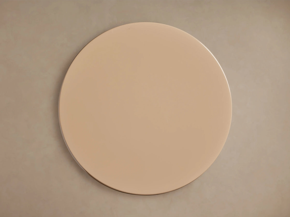 Alt text: Close-up of the Bridgers Lacquer Stool showing its smooth, high-gloss beige finish and sleek, curved silhouette.