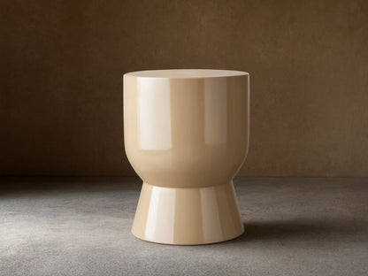 Beige Bridgers Lacquer Stool with a shiny, high-gloss finish. Features a cylindrical top and flared base on a wooden floor.
