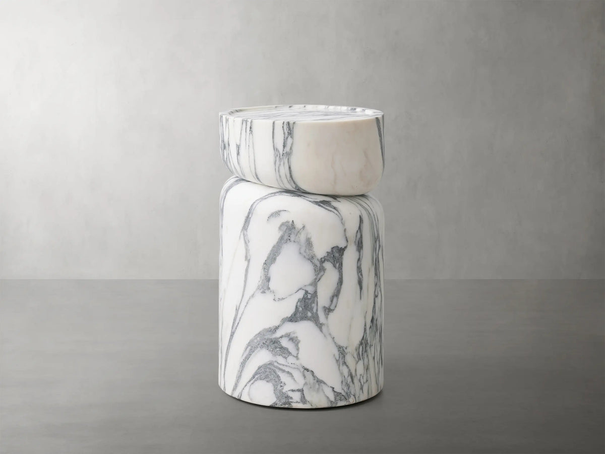 Front view of the white Arabescato Mayer Martini Table, a modern column design with a rounded top and intricate grey veining.