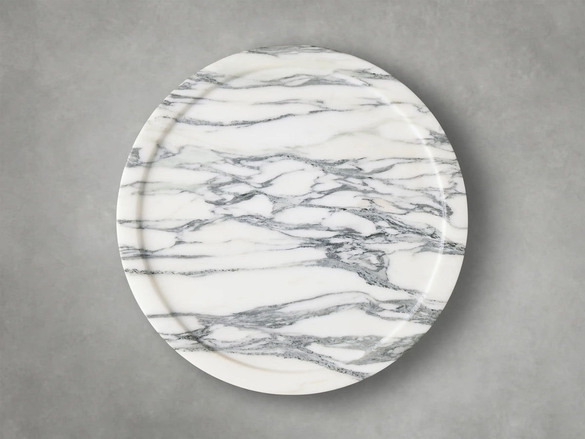 Close-up of the Arabescato Mayer Martini Table™ with intricate grey veining on a white base, highlighting its carved side and subtle tabletop edge.