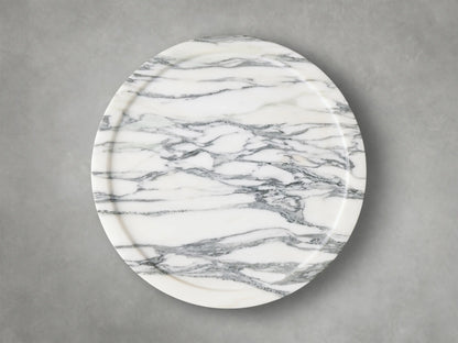 Close-up of the Arabescato Mayer Martini Table™ with intricate grey veining on a white base, highlighting its carved side and subtle tabletop edge.