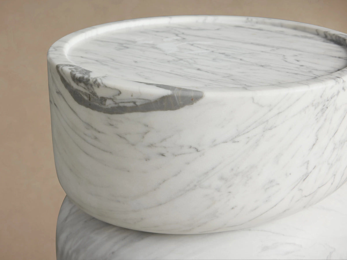 Alt text: Close-up of Mayer Martini Table top, showing smooth white stone surface with unique gray veining and subtle carved edges.