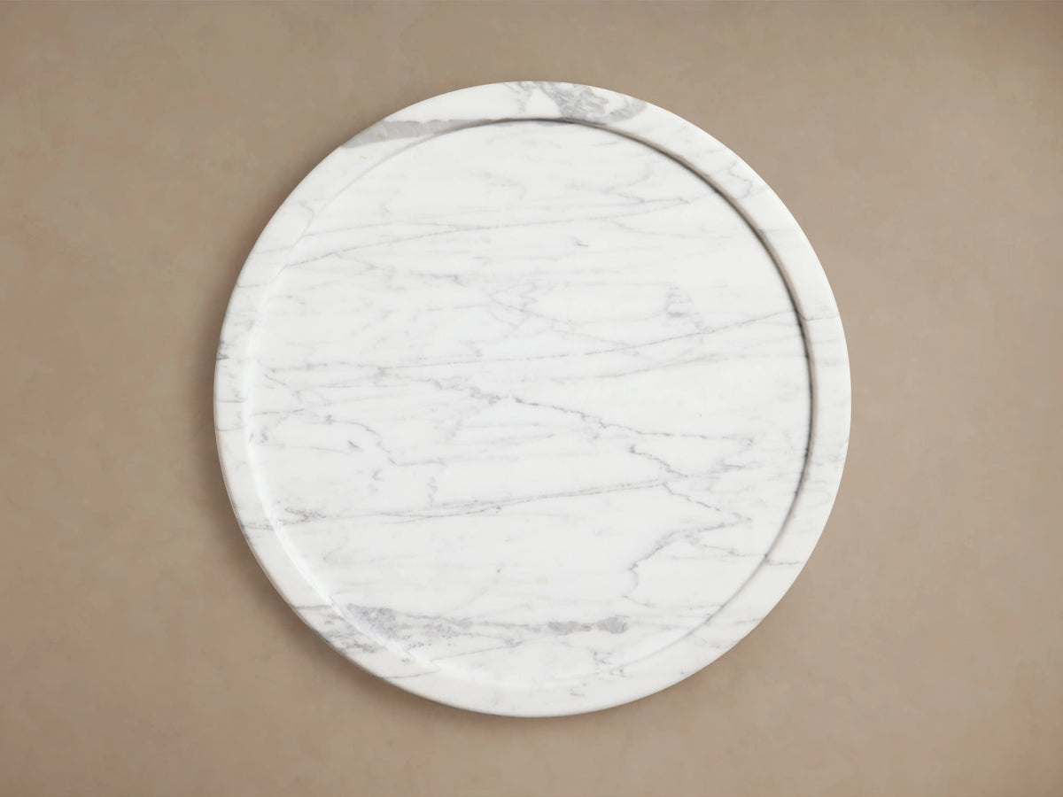 Mayer Martini Table with a modern column silhouette, carved detailing, and gray veining on smooth, white natural stone.