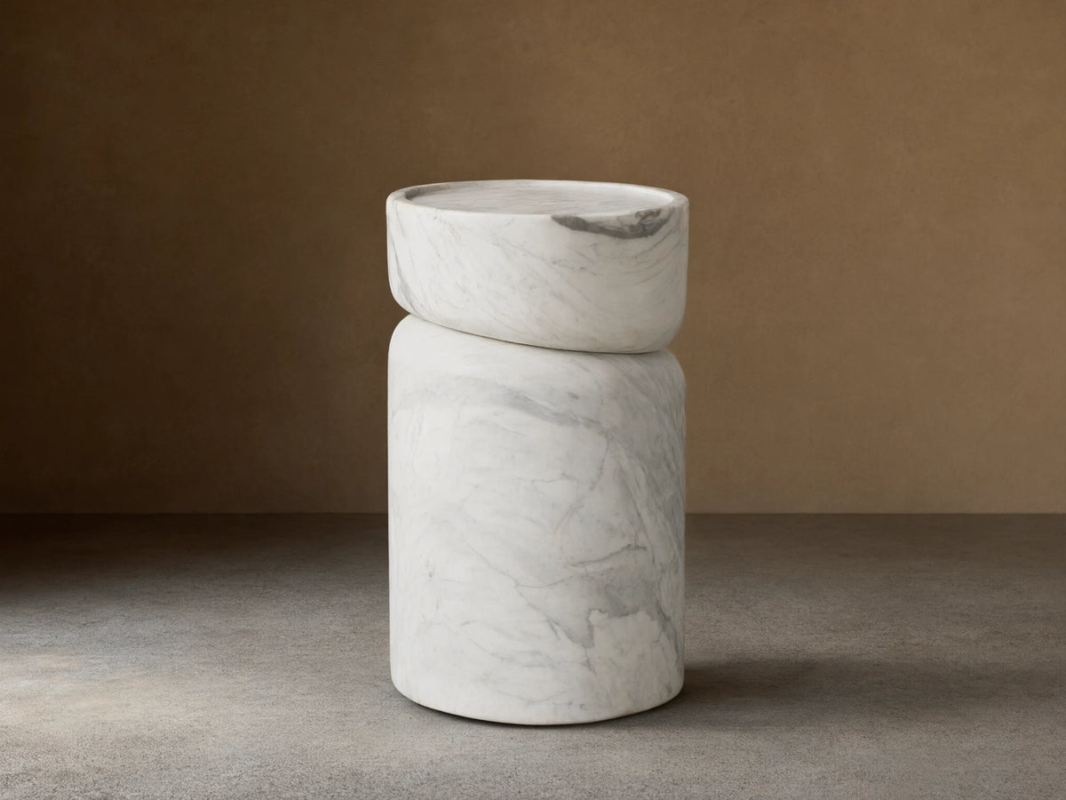 Mayer Martini Table with a modern column silhouette, carved detailing, and gray veining on smooth, white natural stone.