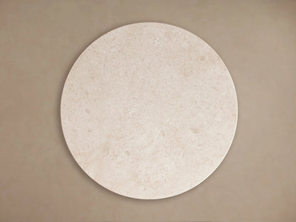 Caden Round Coffee Table close-up. Cream stone top with natural patterns and a dark walnut wood veneer base with an antique bronze plinth.