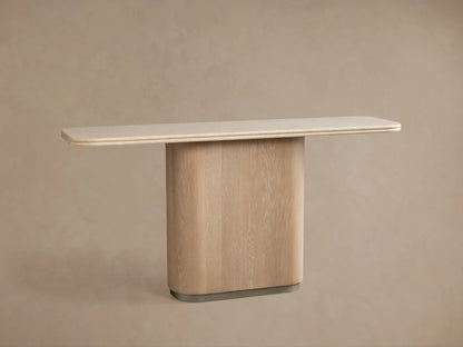 Caden Console Table with cream stone top, light sand oak curved base, and brushed nickel plinth against a taupe wall.