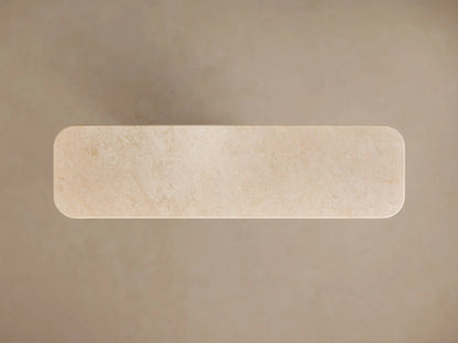 Close-up of Caden Console Table: Cream stone top with rounded, layered edge above a light sand oak wood veneer base.