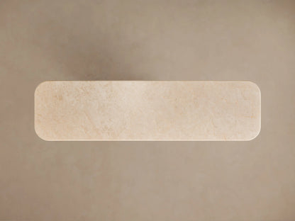 Angled close-up of Caden Console Table. Cream stone top with subtle veining, double rounded edge, light sand oak veneer base.