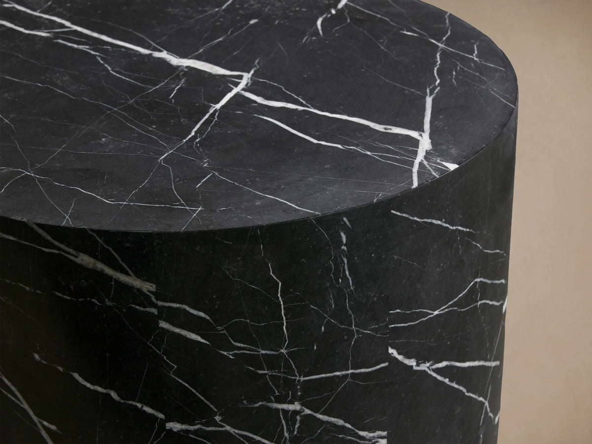 Cylindrical Cinzia Stone End Table with a smooth, dark surface featuring white veining patterns, creating an elegant, natural look.