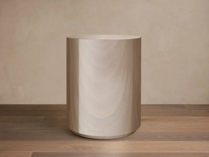 Front view of the Cinzia Chrome Round End Table, a cylindrical piece with a radiant, polished, mirror-like finish and a plinth-style base.