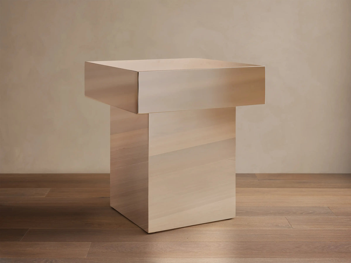 Front view of Cinzia Chrome End Table, featuring a rectangular chrome top and a light wood plinth base.