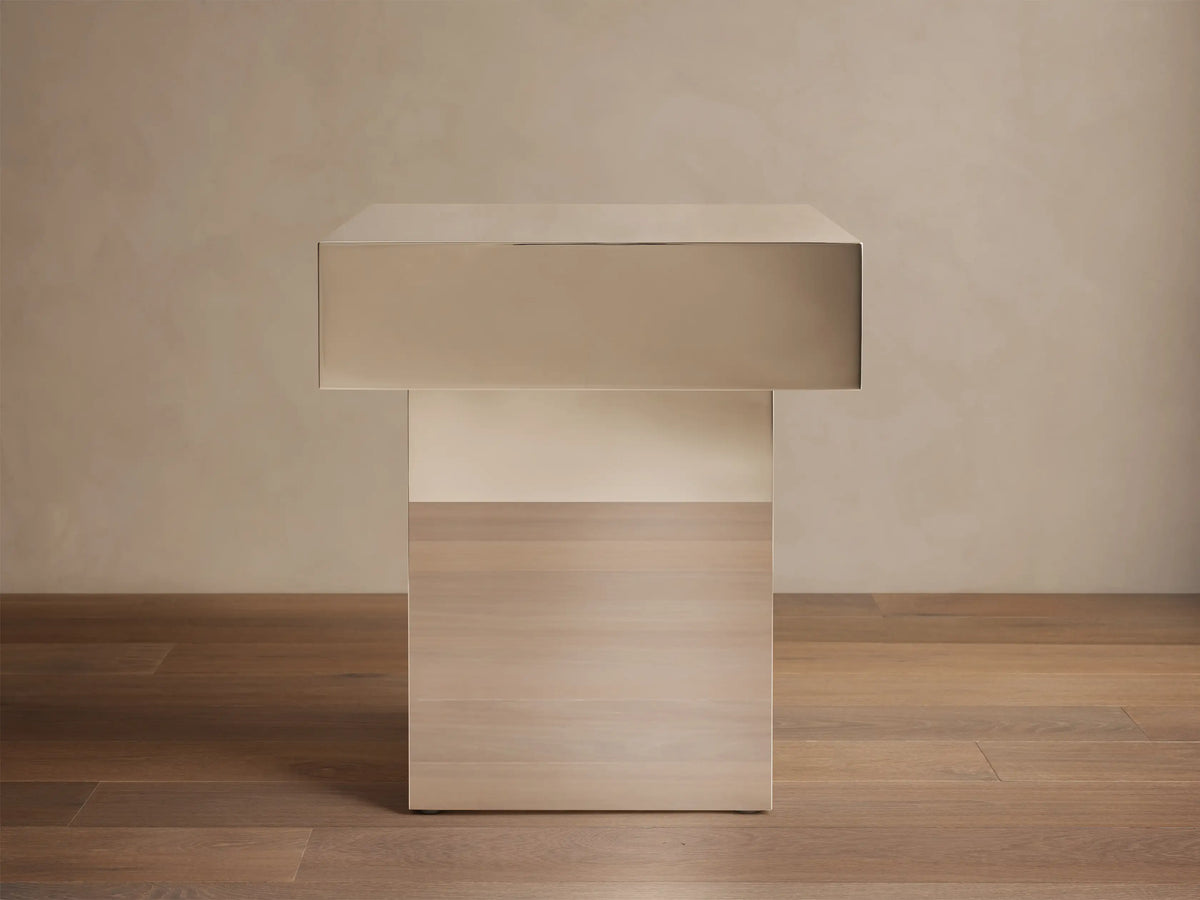 Front view of Cinzia Chrome End Table, featuring a rectangular chrome top and a light wood plinth base.
