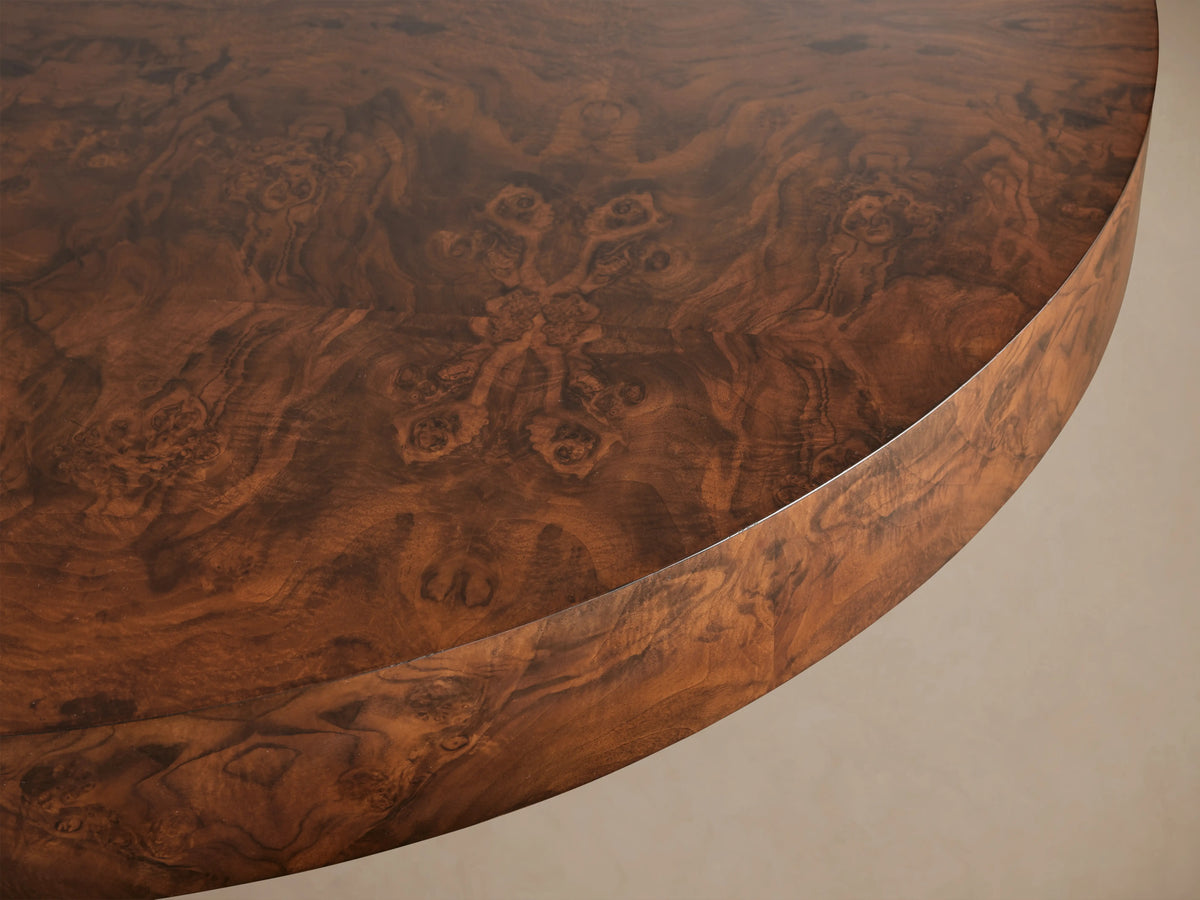 Cinzia Burl Round Coffee Table, low-profile with dark brown walnut burl wood and intricate swirling grain patterns, on a plinth base.