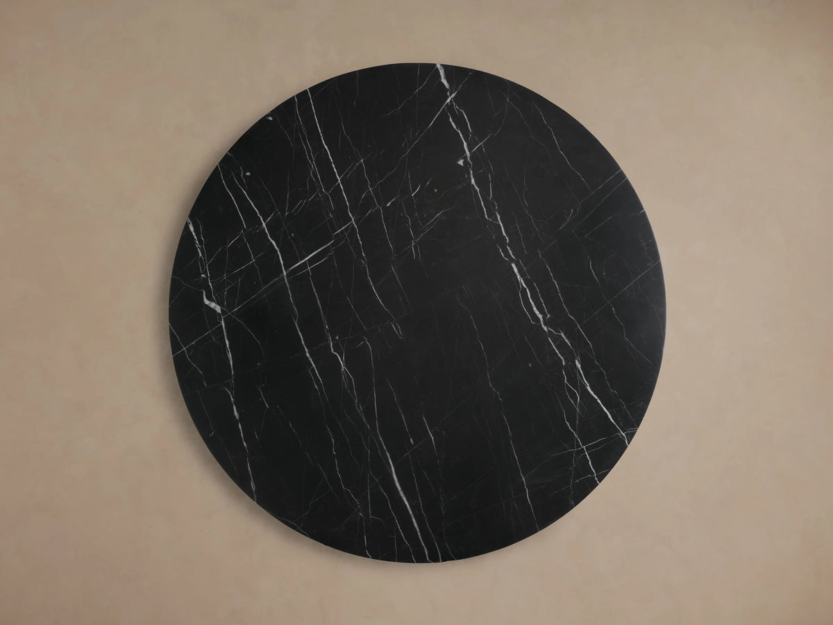 Cinzia Stone Round Coffee Table with black marble finish, featuring white veining and a low-profile, plinth-style base.