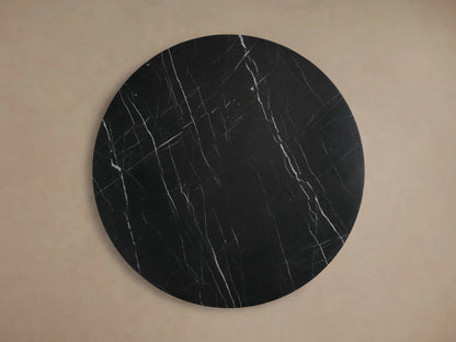 Close-up angled view of Cinzia Stone Round Coffee Table. Black marble with distinctive white veining, round top and base.
