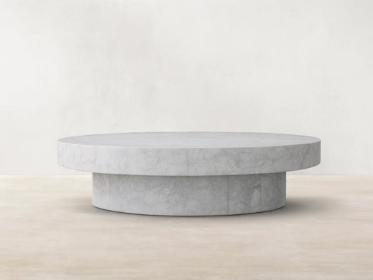Cinzia Stone Round Coffee Table made of natural marble with visible veining, low-profile design, and cylindrical plinth base.