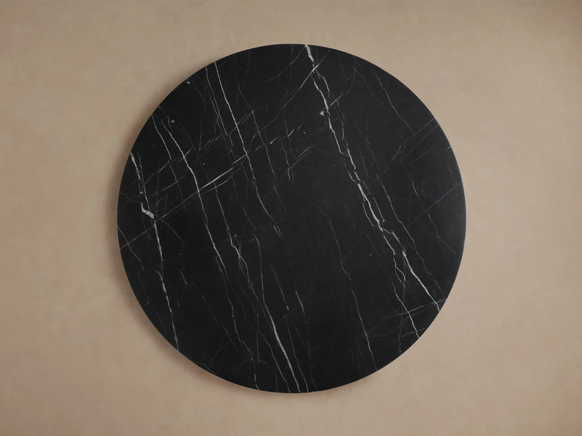 Cinzia Stone Round Coffee Table featuring black marble with white veining, plinth-style base, and a smooth, polished finish.