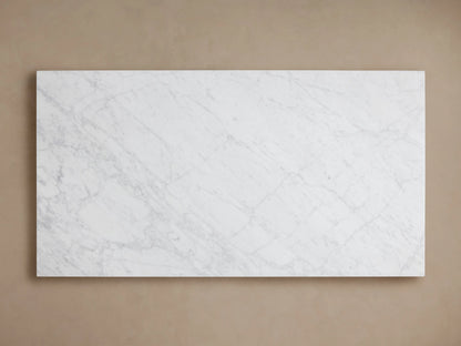 Cinzia Stone Coffee Table with a rectangular white marble surface, featuring subtle grey veining, set on a plinth-style base.