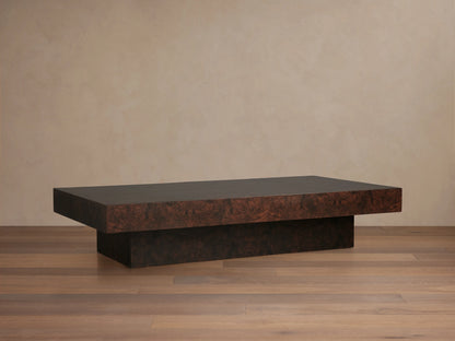 Cinzia Burl Coffee Table in walnut burl wood veneer with a low-profile, rectangular design on a plinth-style base, displayed on wood flooring.