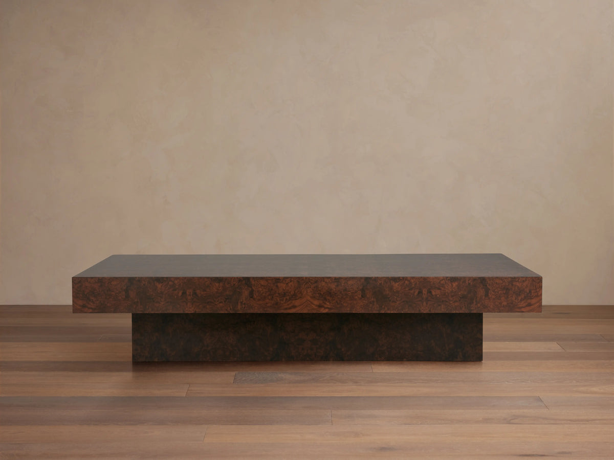 Cinzia Burl Coffee Table top view showing intricate walnut burl wood veneer with symmetrical, bookmatched patterns and rich brown tones.