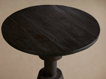 Caledonia Martini Table with round top, crafted from dark mango wood. Seen from above, showing wood grain and texture.