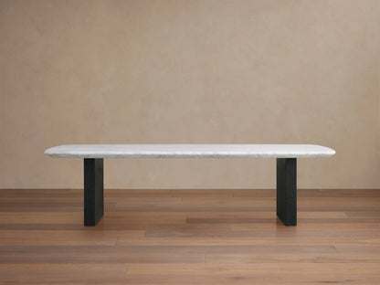 Saint Germain Stone Top Coffee Table with white marble top and dark wooden base, set on wood floor against beige wall.