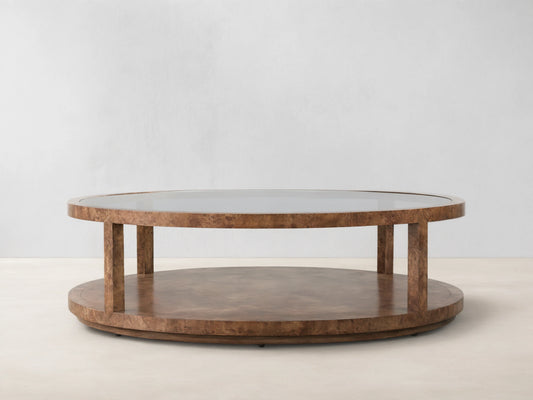 Corey Round Coffee Table in swirling mappa burl wood, featuring a glossy top, round lower shelf, and cylindrical supports.