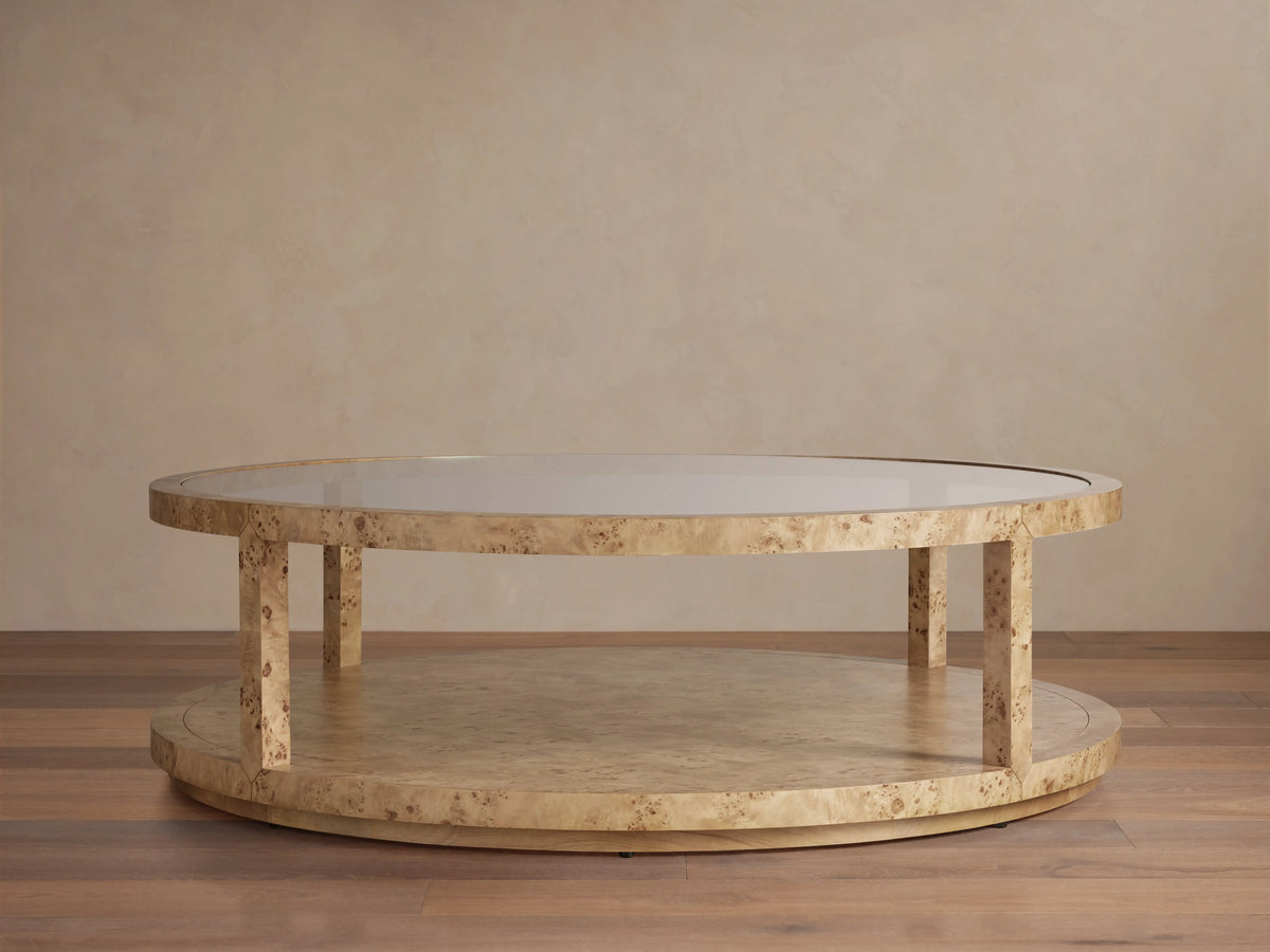 Corey Round Coffee Table in light brown mappa burl wood finish, with circular top and lower shelf connected by vertical supports.