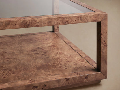 Corey Coffee Table with rectangular design, mappa burl wood texture, glass top, and visible lower shelf, angled view.