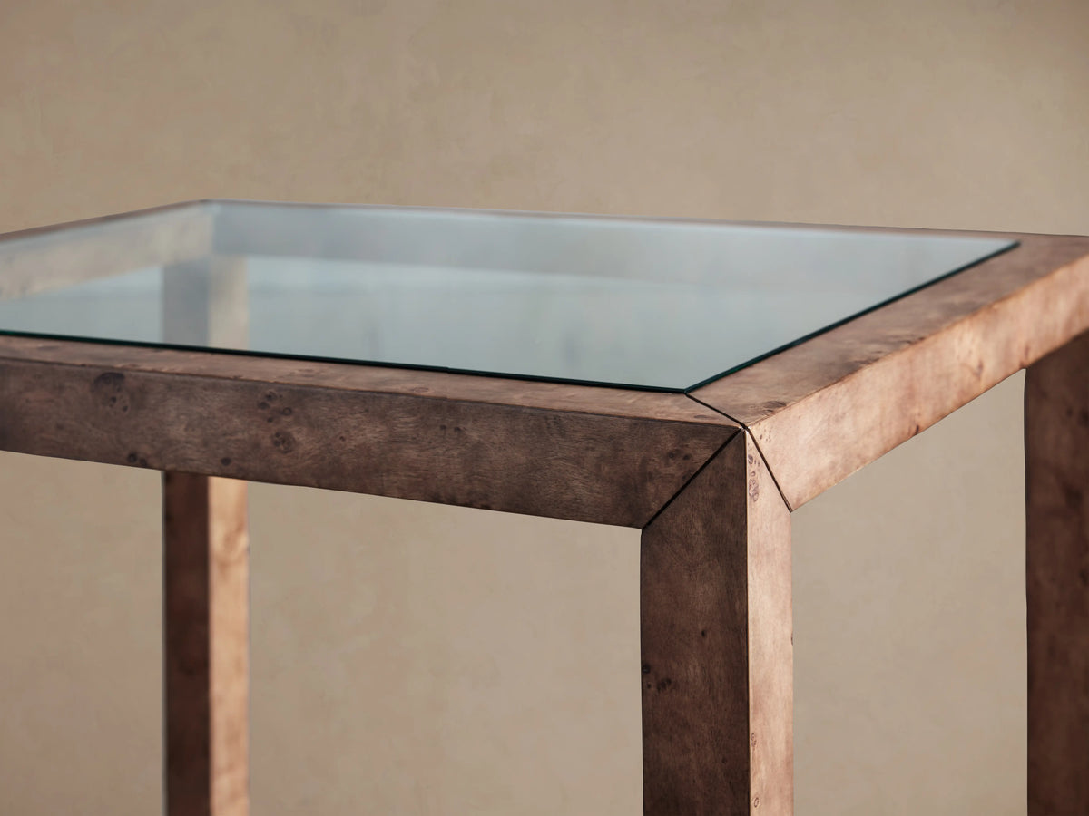 Square Corey End Table, mappa burl wood frame and lower shelf with swirling patterns, clear glass top.