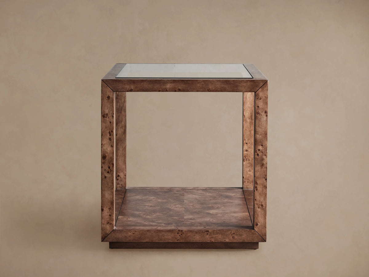 Corey End Table: close-up of brown mappa burl wood frame with a clear glass top and visible mitered corner joint.