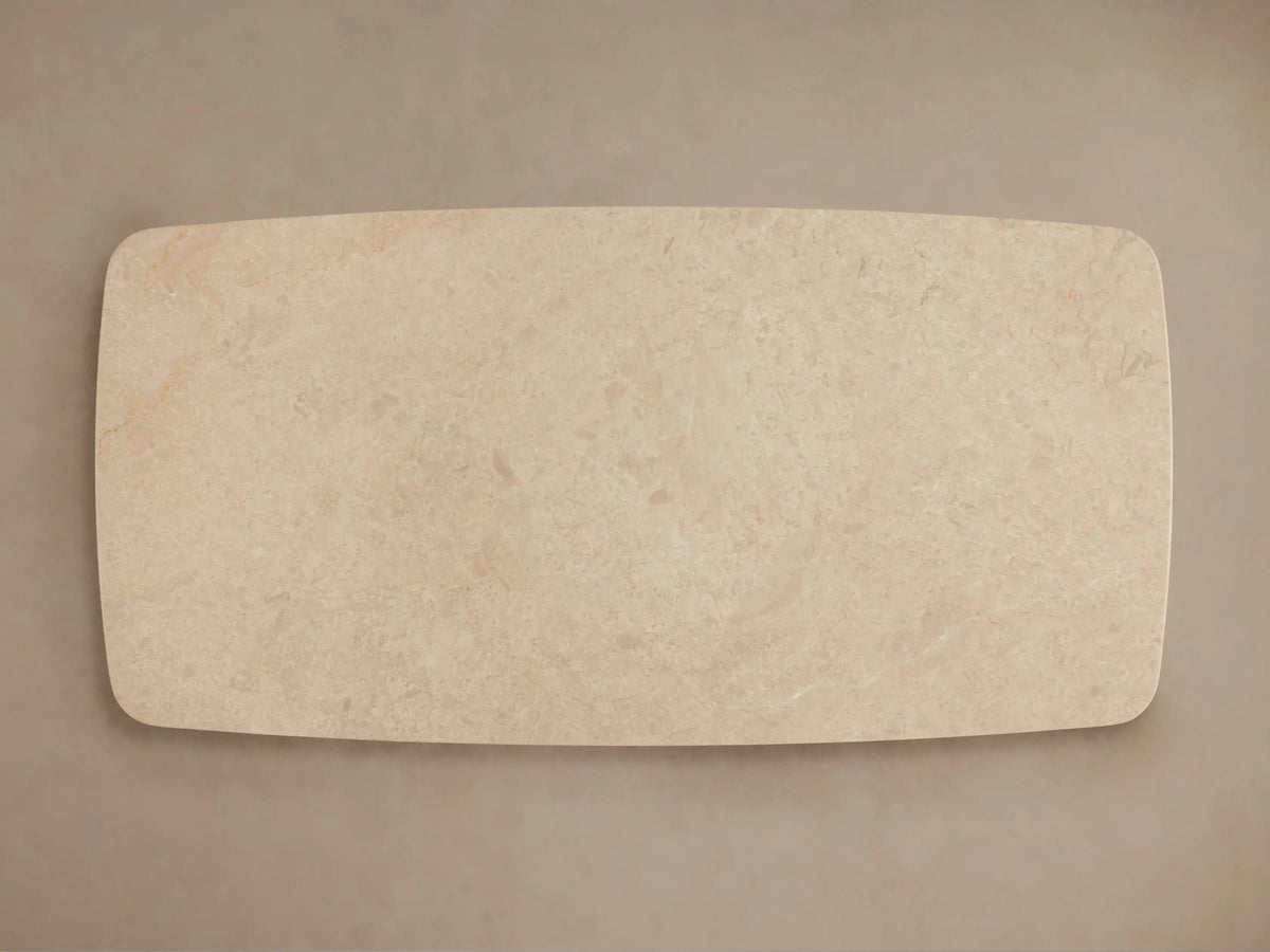 Front view of the Saint Germain Stone Coffee Table with Dauphine Base, showing a light-colored stone top and two dark curved oak veneer bases.