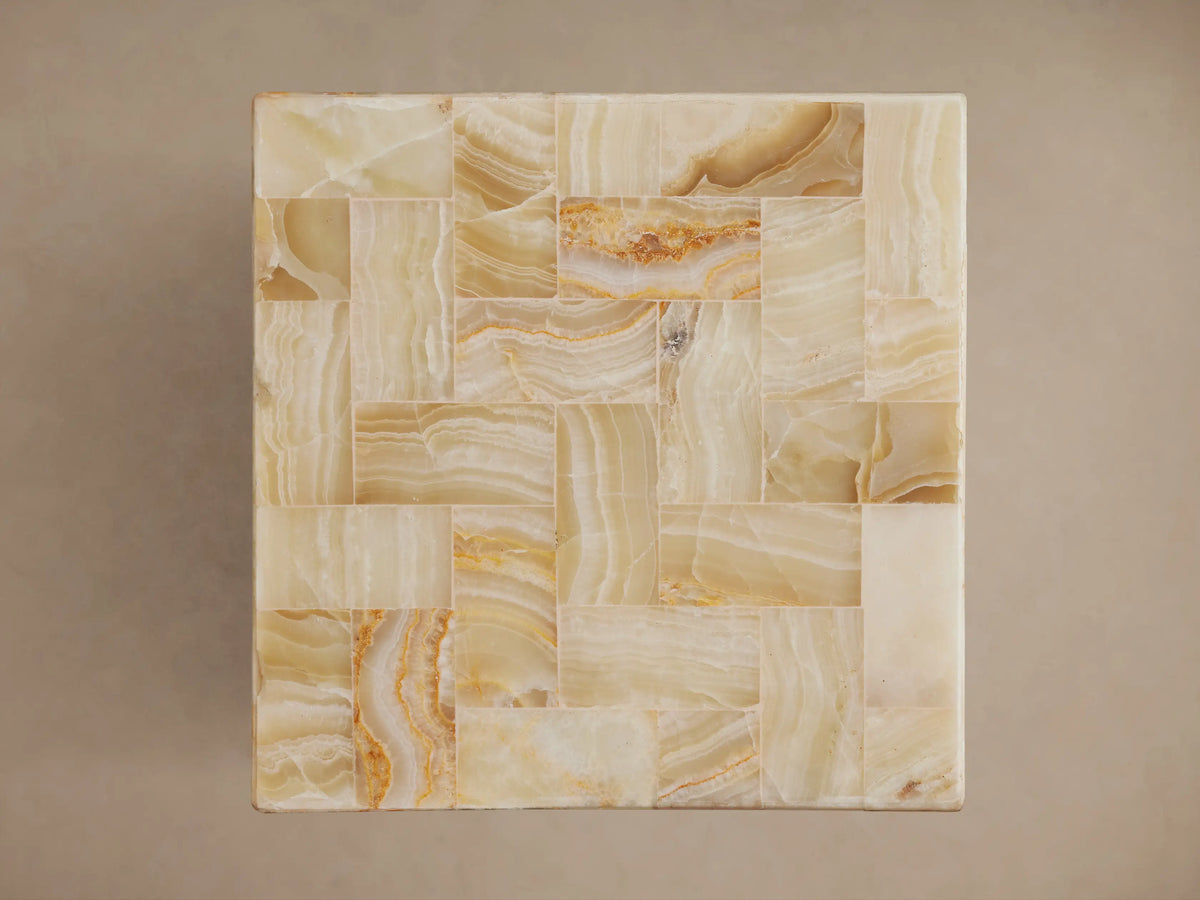 Dasha Onyx Stool featuring a mosaic of ivory, light green, and rust onyx tiles, with smooth, polished edges.