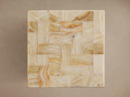 Dasha Onyx Stool featuring a mosaic of ivory, light green, and rust onyx tiles, with smooth, polished edges.