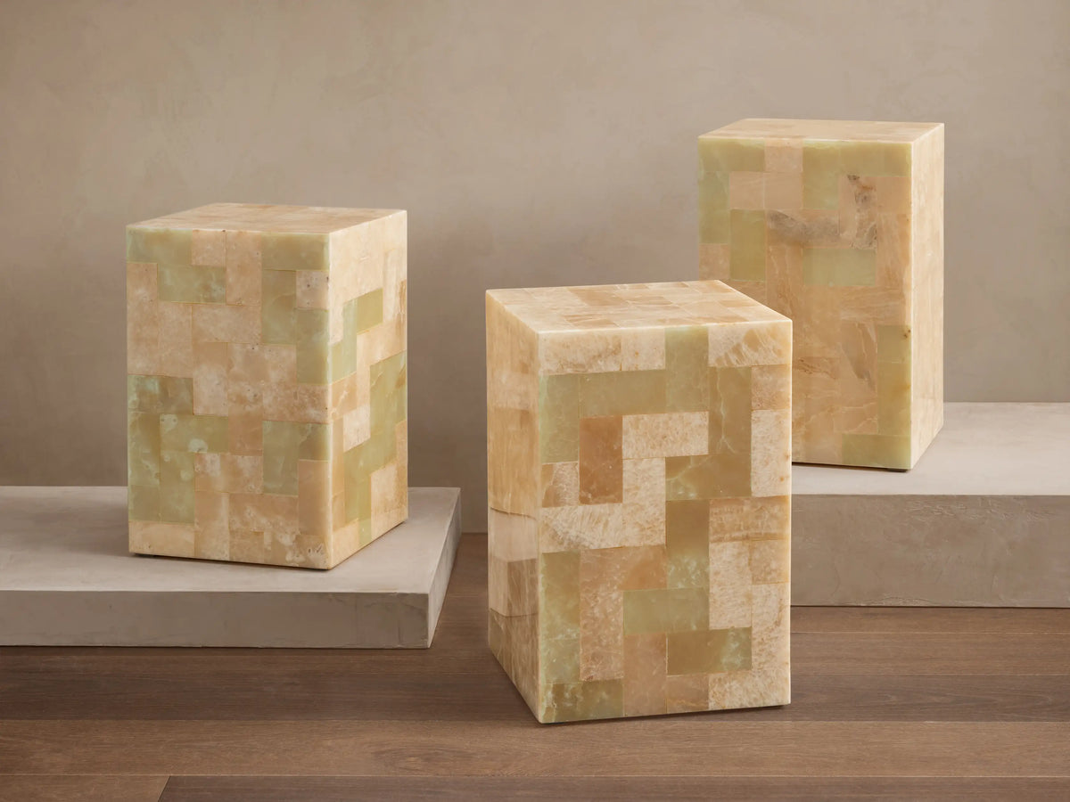 Square view of Dasha Onyx Stool top featuring a mosaic of ivory, light green, and rust-toned onyx tiles in various patterns.