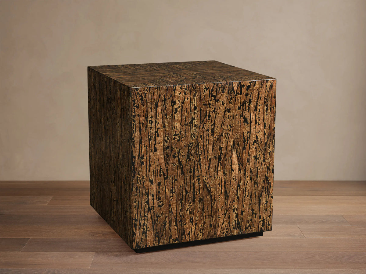 Desi End Table, close-up of rich brown kapok wood veneer top with distinct black resin filling natural openings, in a chevron pattern.