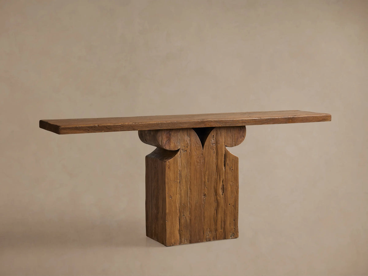 Brown Dumai Console Table, a wall-mounted reclaimed teak wood shelf with a carved support bracket and waxed natural finish.