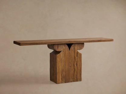 Brown Dumai Console Table, a wall-mounted reclaimed teak wood shelf with a carved support bracket and waxed natural finish.