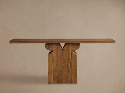 Rustic Dumai Console Table with a solid wood top, natural wood grain, and an intricate carved base in a warm brown finish.