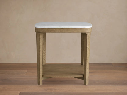 Danny End Table with an ivory-toned marble top and oak wood frame. Elegant square design with a lower shelf, set against a neutral wall.