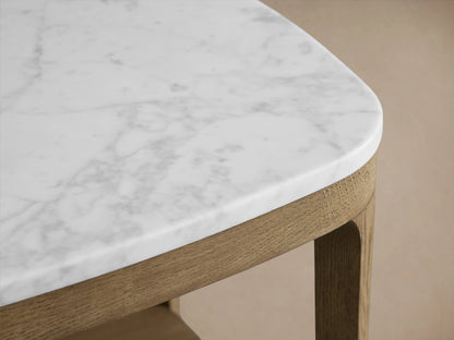Danny End Table with an oak wood frame in a fawn finish, featuring a white marble top. The table has a lower shelf and is set against a neutral background.