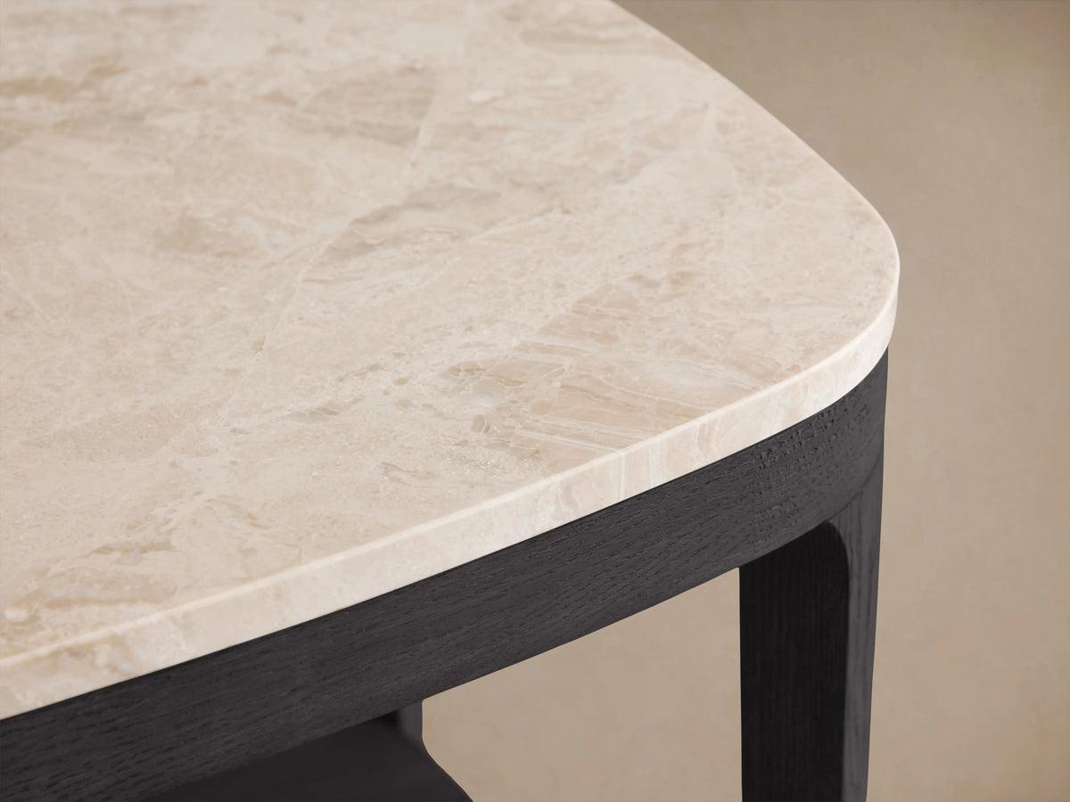 Danny End Table with ebony finish oak frame, white marble top, and lower shelf; set on wooden floor against beige wall.