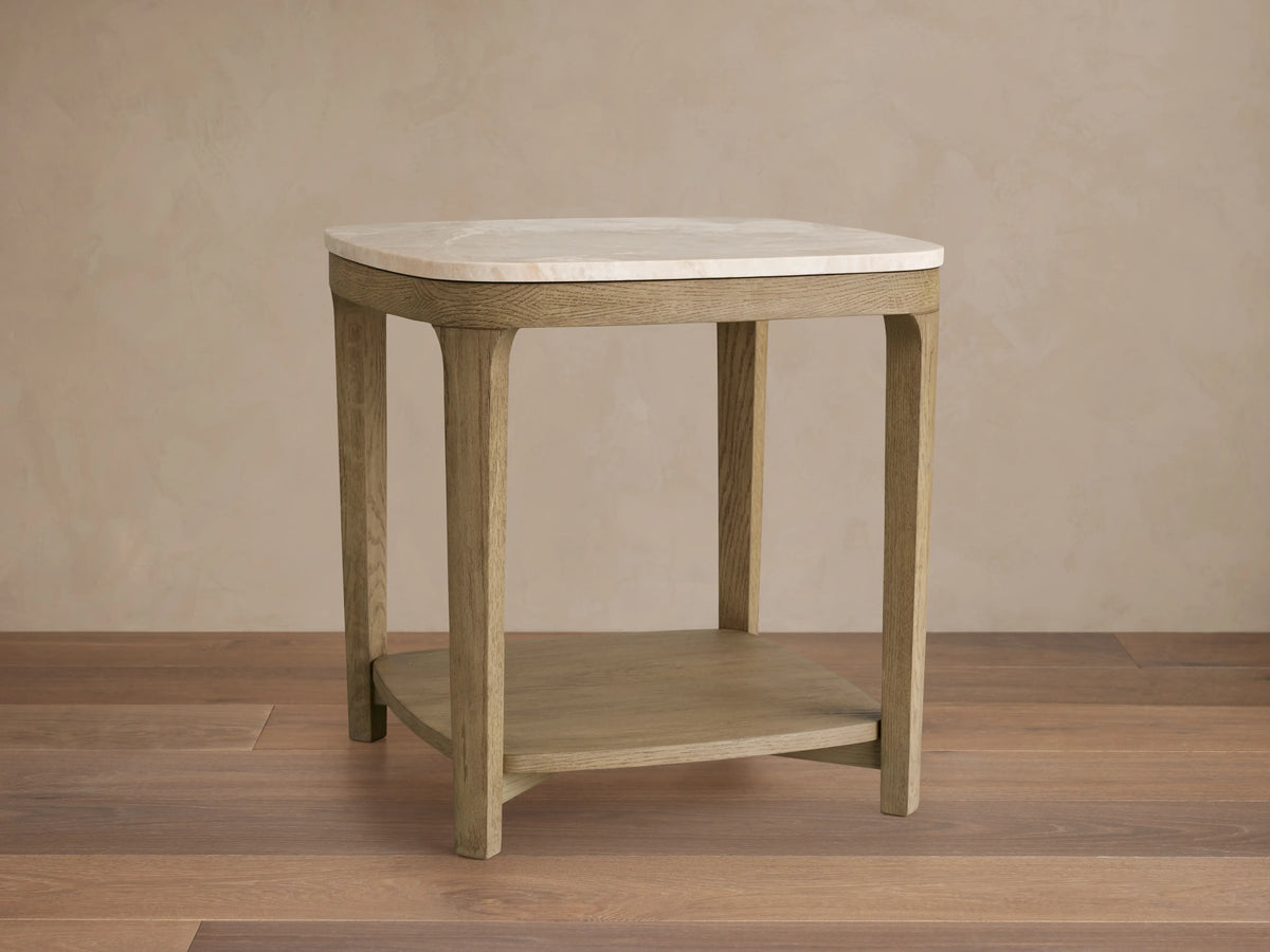 Danny End Table with ivory-toned marble top and oak wood frame in fawn finish on a wooden floor.