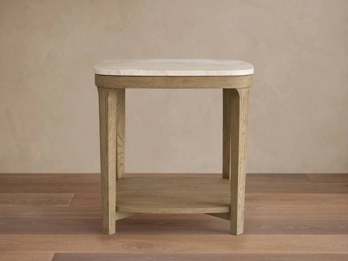 Danny End Table with ivory-toned marble top and oak wood frame in fawn finish on a wooden floor.