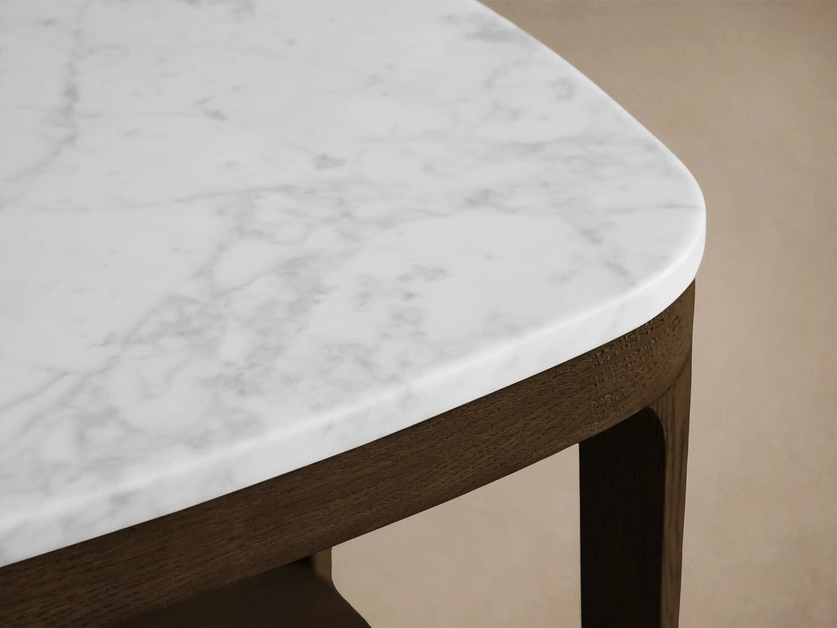 Front view of a dark brown wood side table with a white marble top and a matching lower shelf.