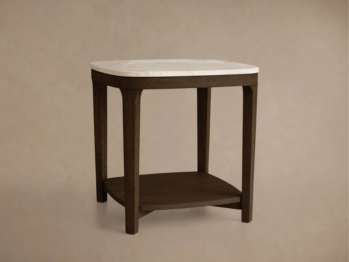 Front view of side table: dark brown wood frame, white marble top, lower storage shelf, rounded edges.
